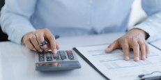 Office employee with clipboard and calculator